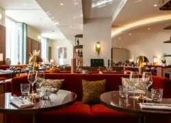 a restaurant with tables and chairs and a red couch