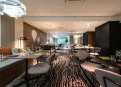 a restaurant with tables and chairs and a zebra print carpet