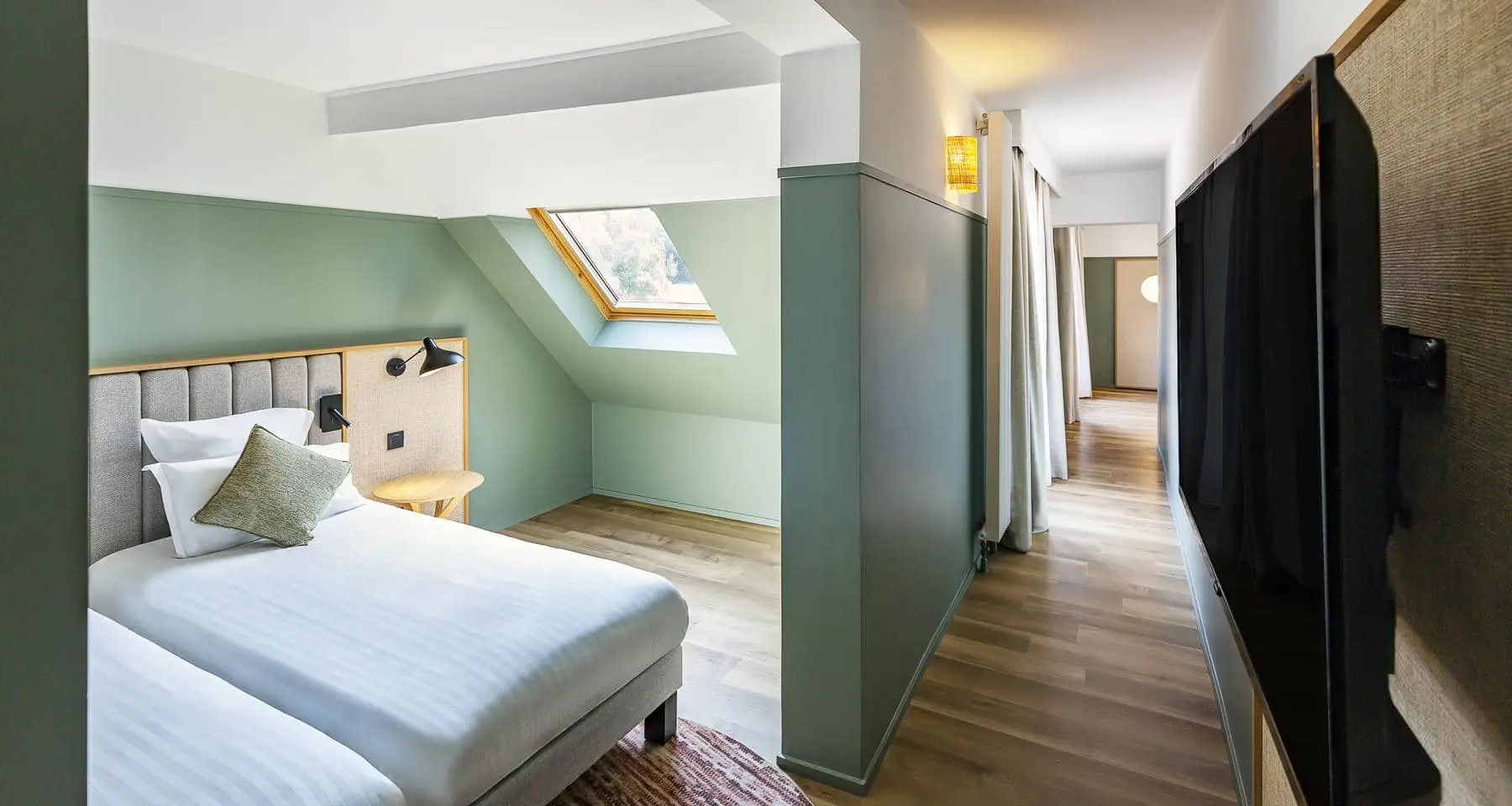 une chambre d'hôtel avec deux lits et une télévision à écran plat