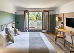 a hotel room with a large bed and a flat screen tv