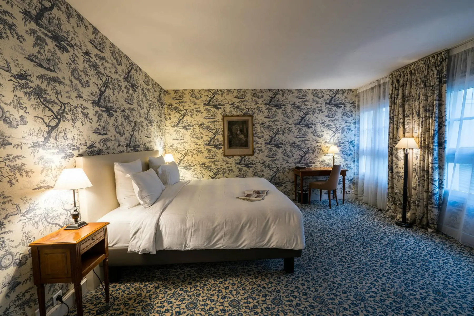 a hotel room with a bed and a desk