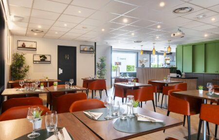 un restaurant avec des tables et des chaises et un panneau indiquant "crêperie"