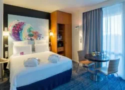 a hotel room with a bed and a small table