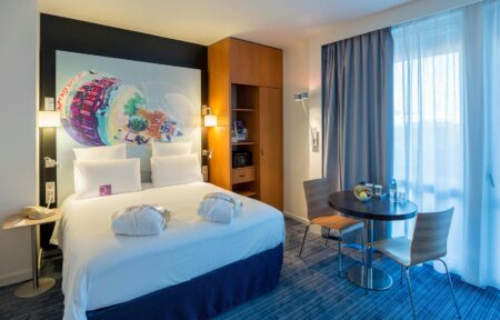 a hotel room with a bed and a small table