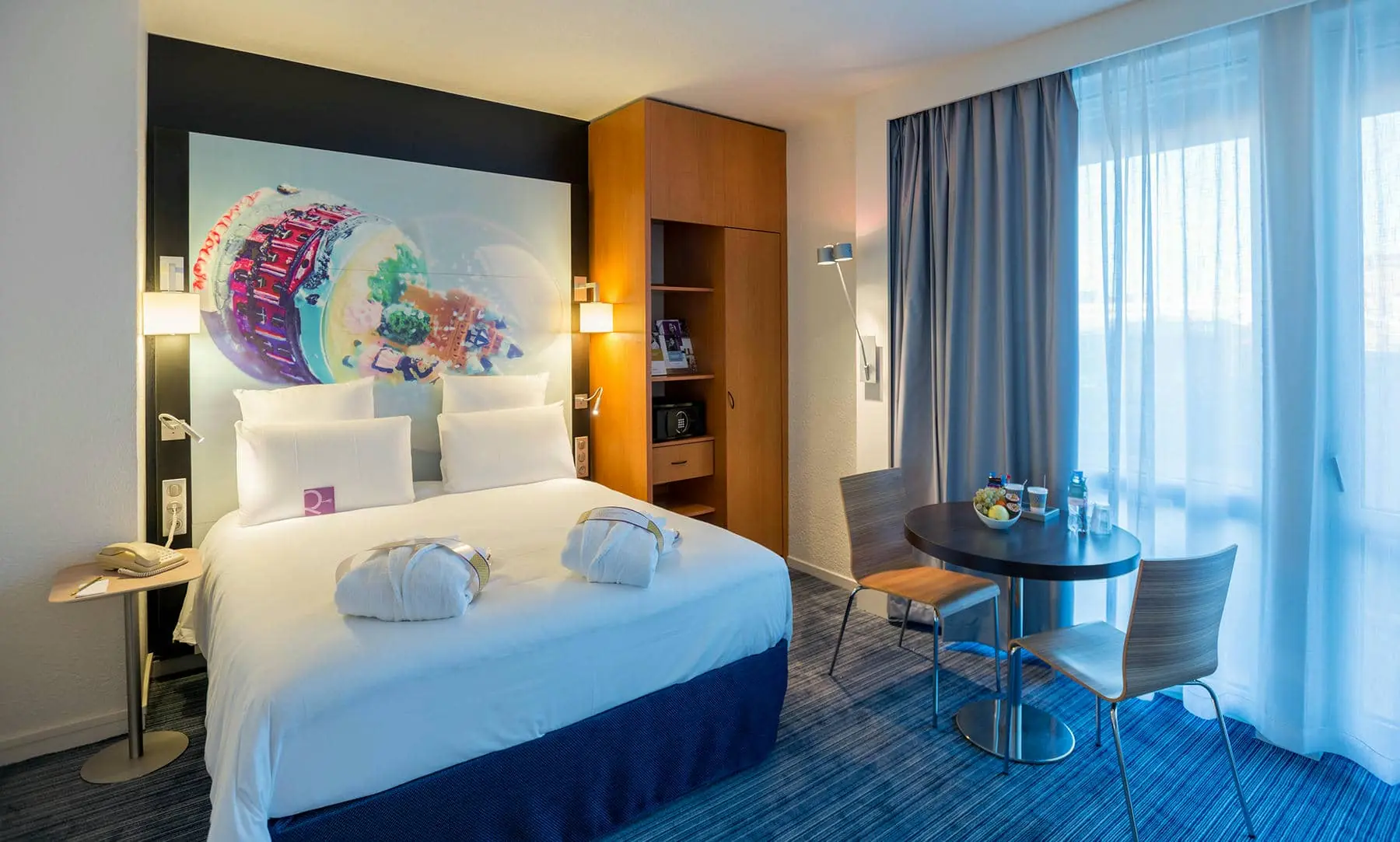 a hotel room with a bed and a small table