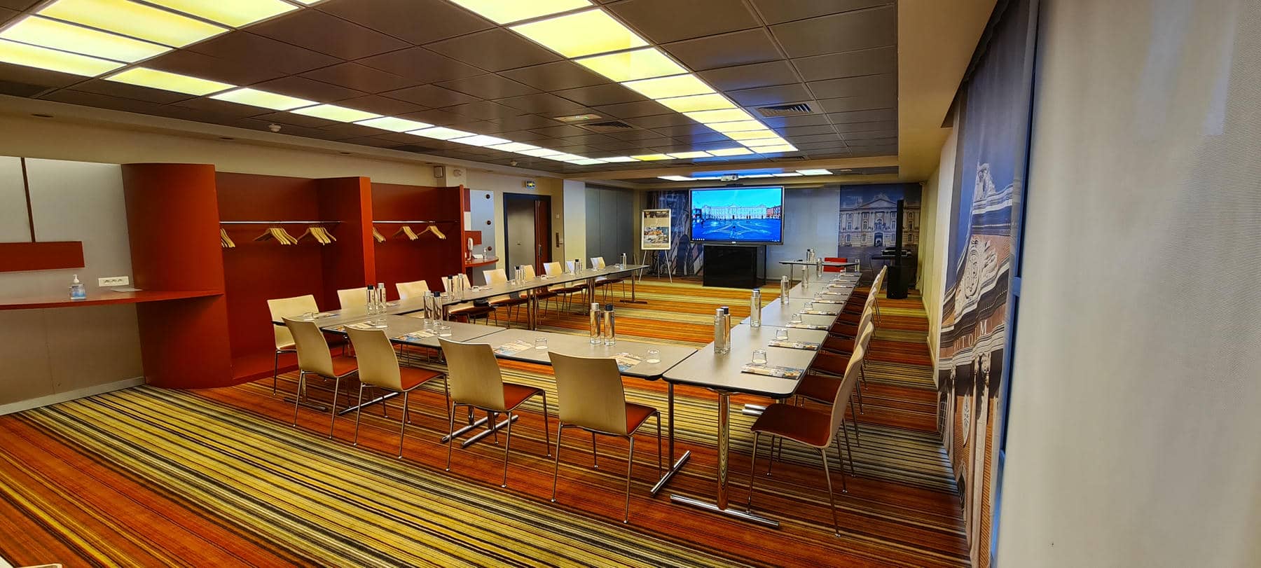 a conference room with long tables and chairs