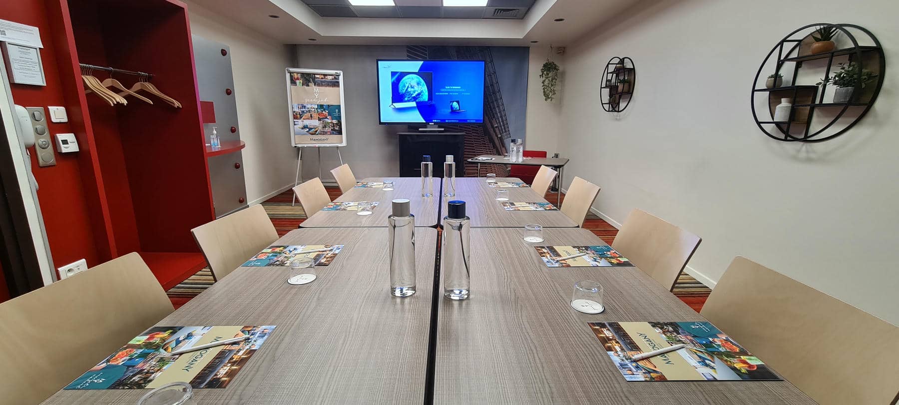a conference room with a table and chairs set up for a meeting