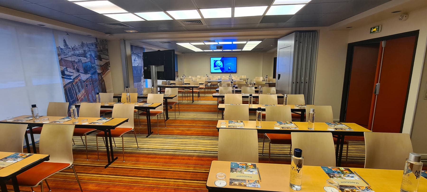 a conference room with tables and chairs set up for a meeting