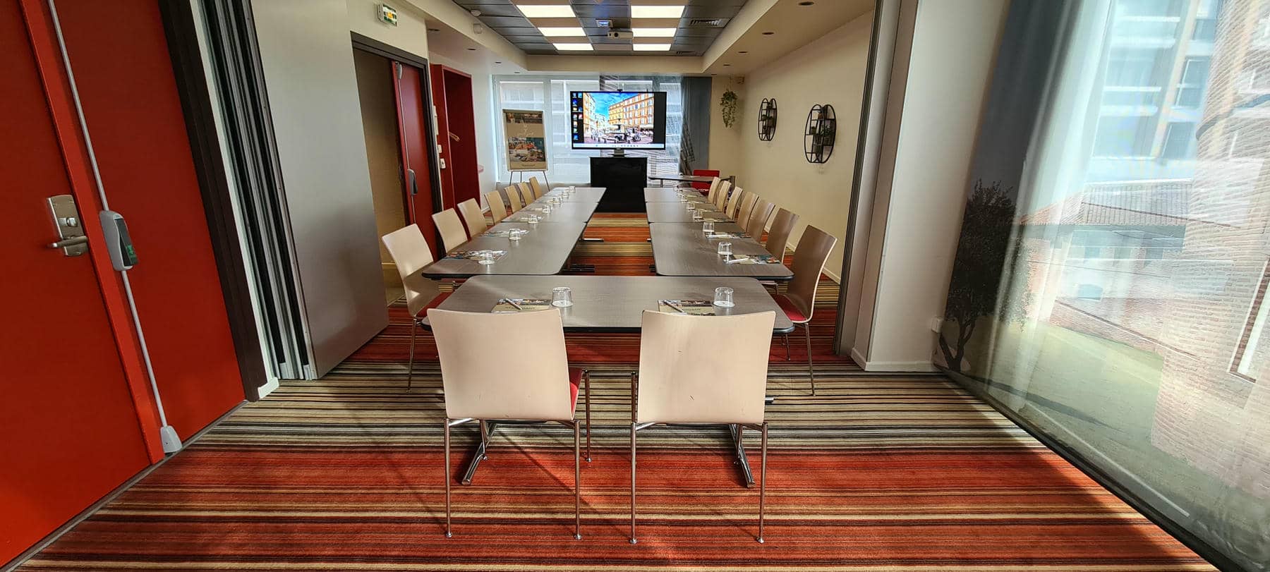 a conference room with long tables and chairs