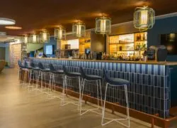 a bar with stools and a menu on the counter