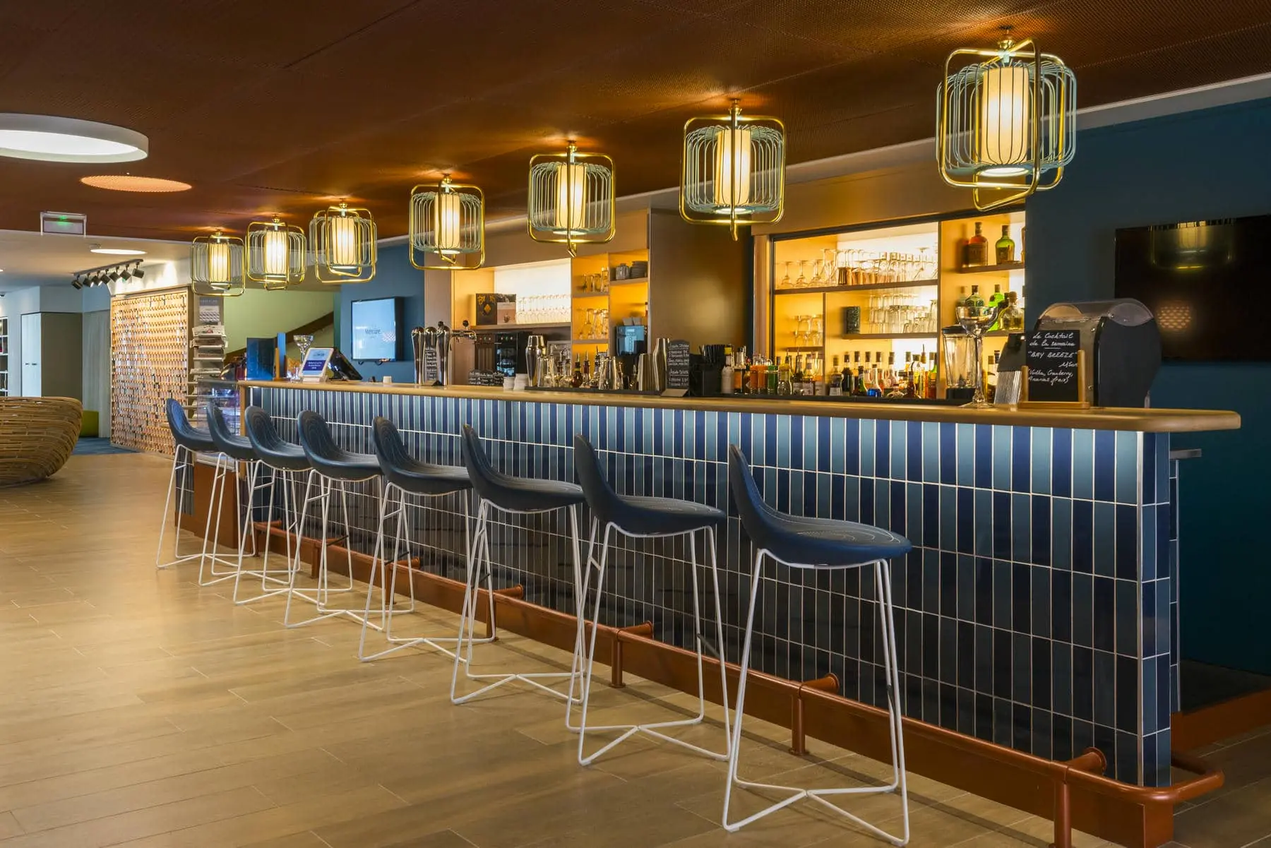a bar with stools and a menu on the counter