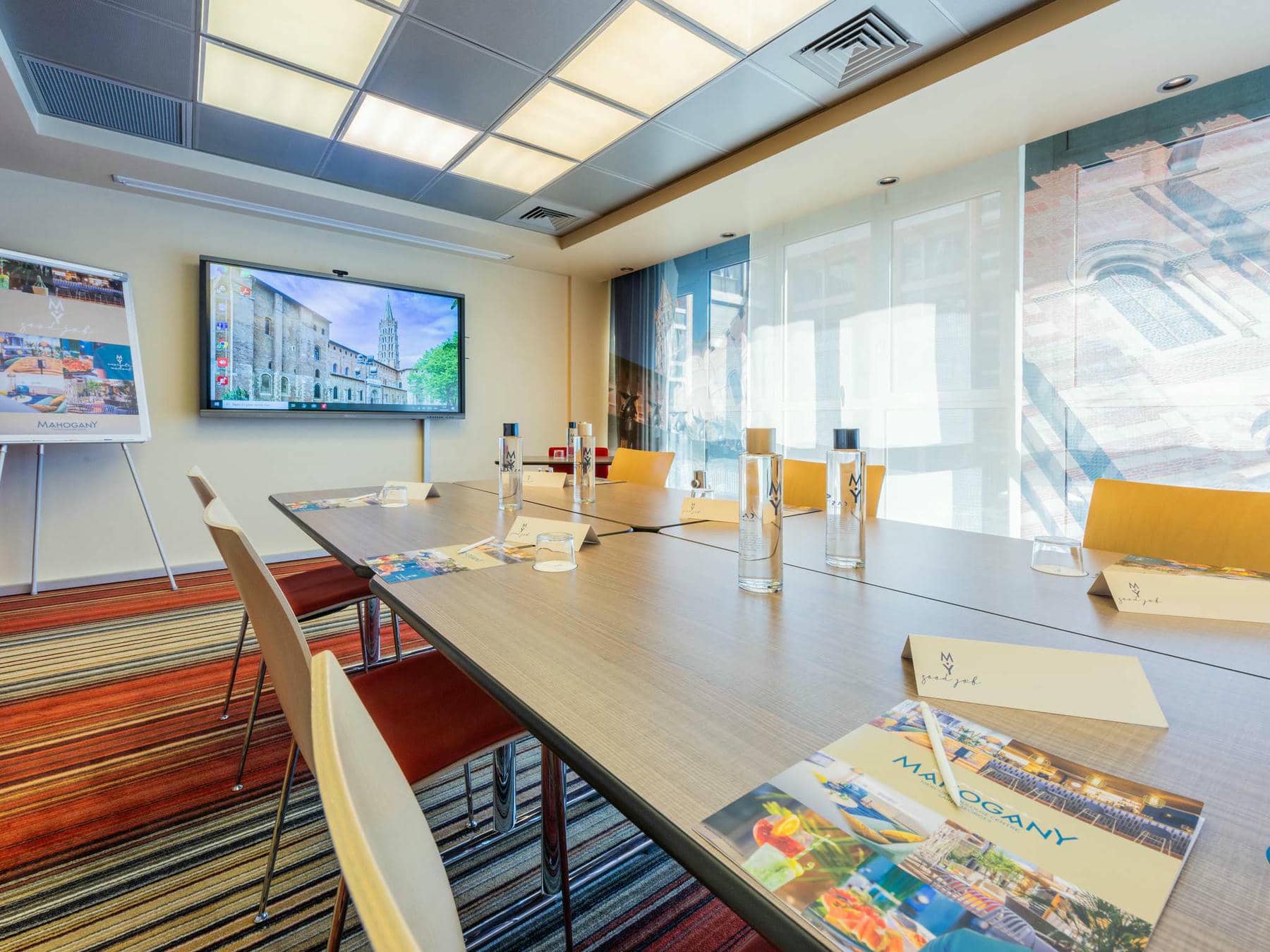 a conference room with a mahogany brochure on the table