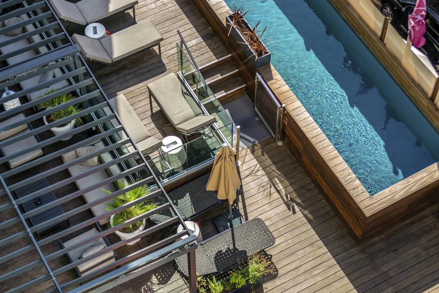 an aerial view of a deck and swimming pool