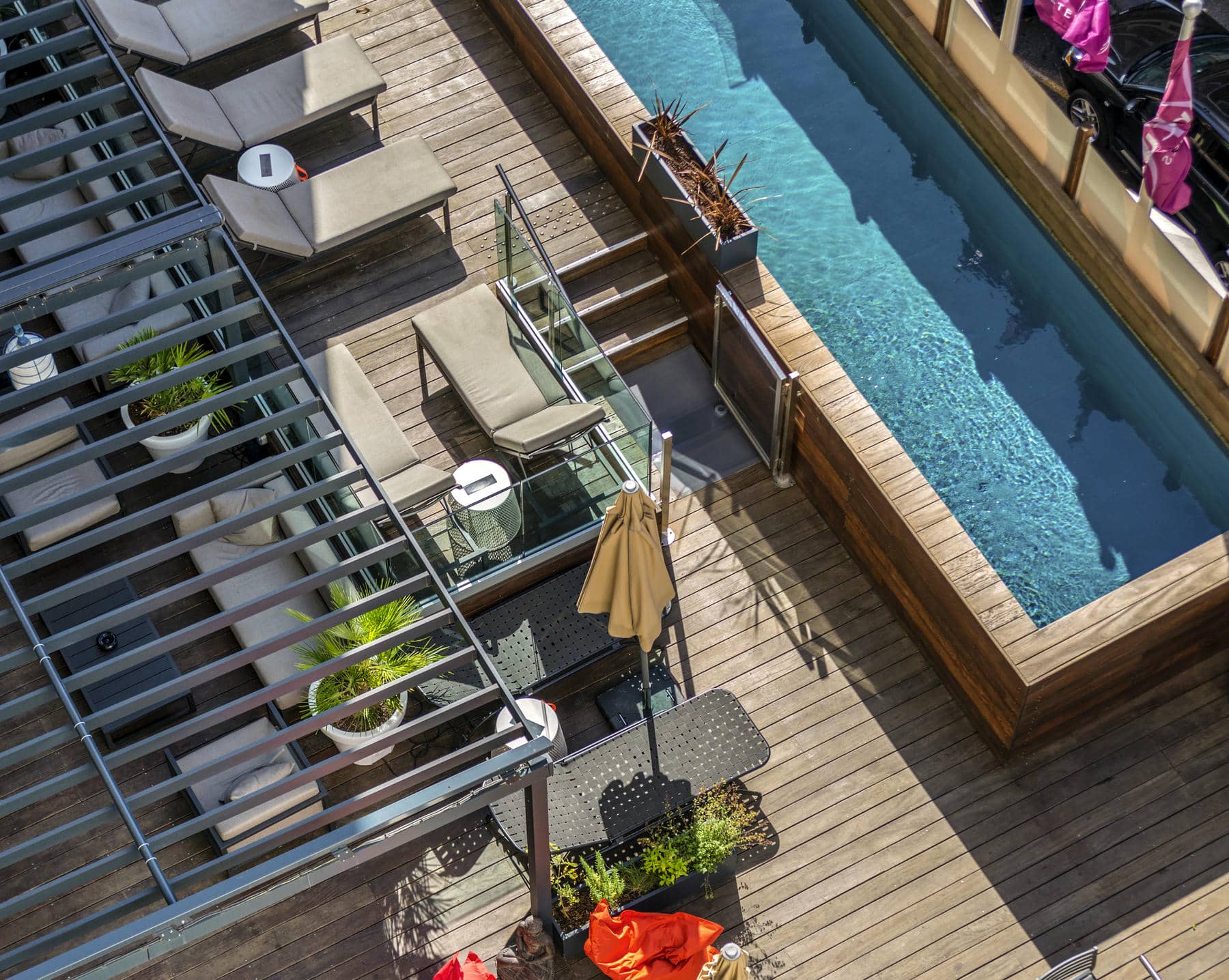 an aerial view of a deck and swimming pool