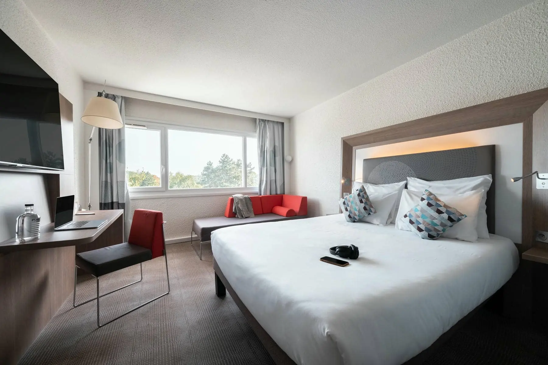 une chambre d'hôtel avec un grand lit et une chaise