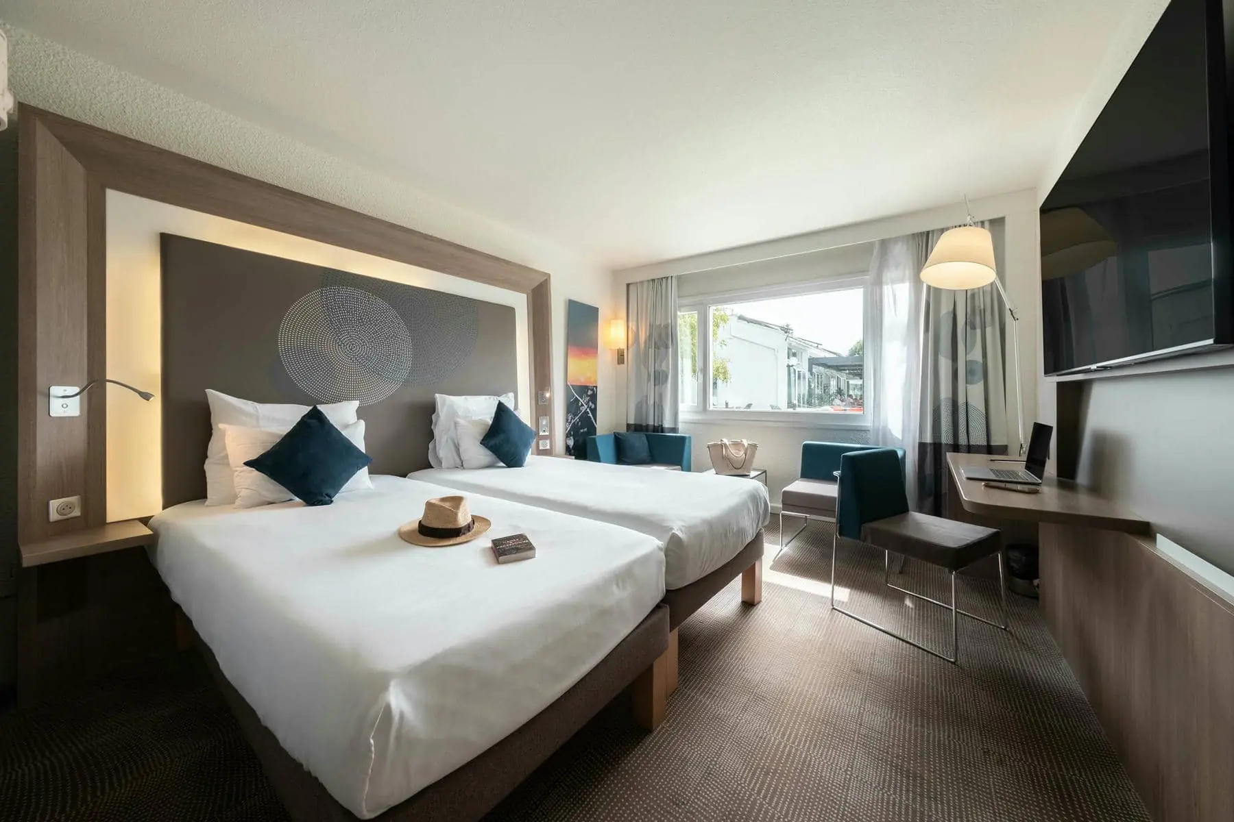 une chambre d'hôtel avec deux lits et un bureau