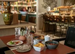 a table with plates and bowls of food on it