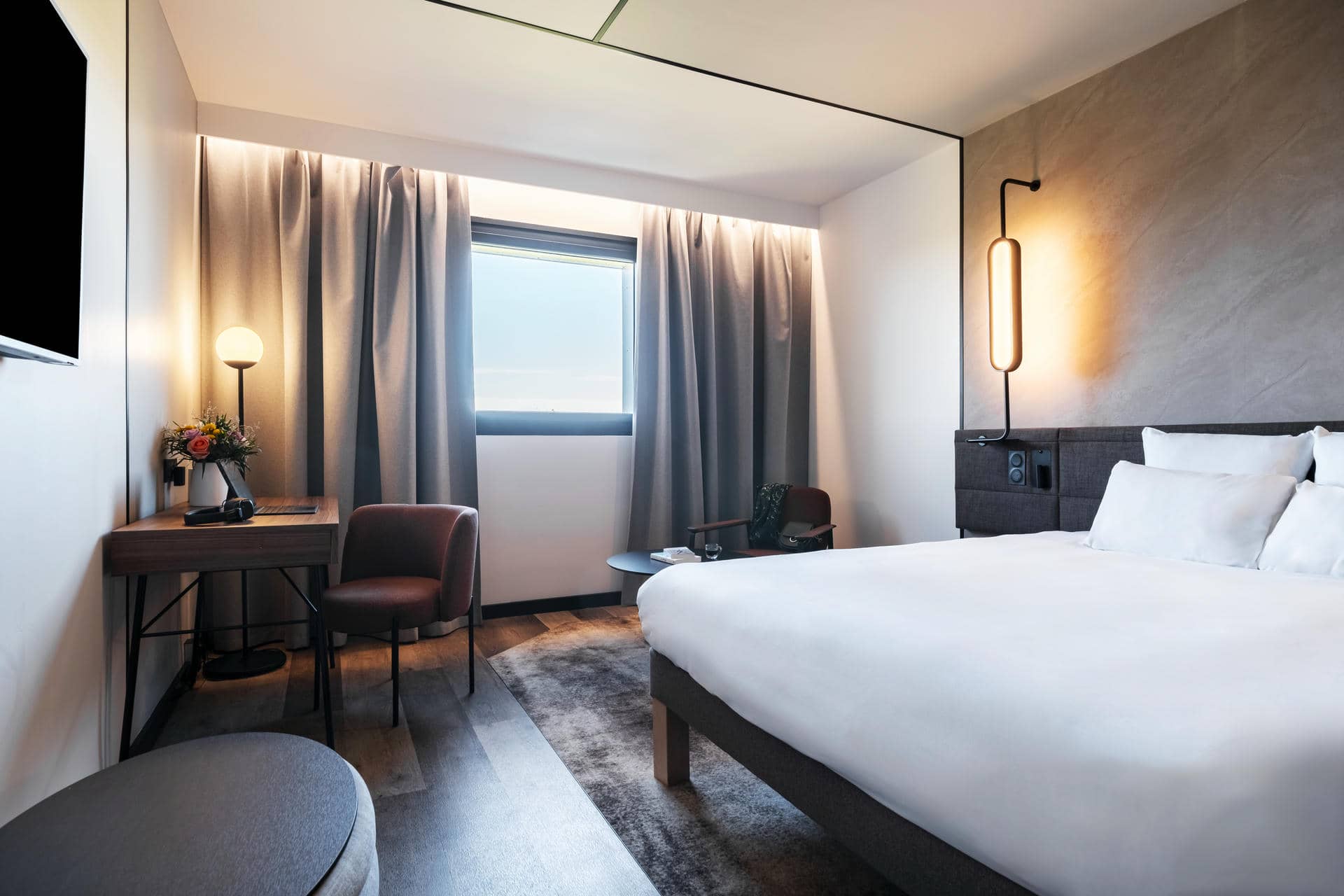 une chambre d'hôtel avec un lit, un bureau et une chaise