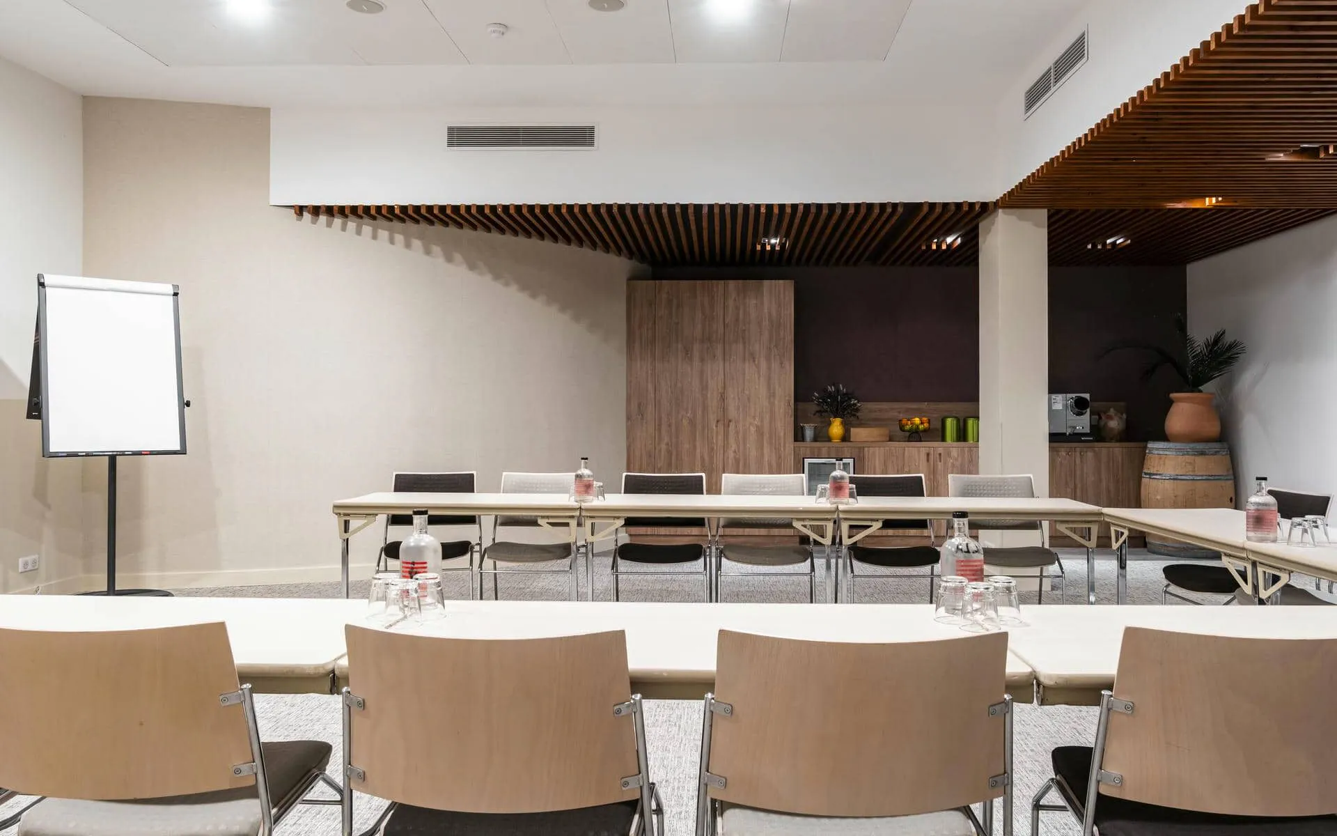 a conference room with tables and chairs and a white board