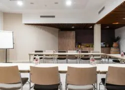 a conference room with tables and chairs and a white board