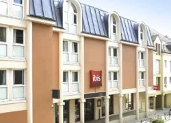 a building with a red sign that says ibis on it