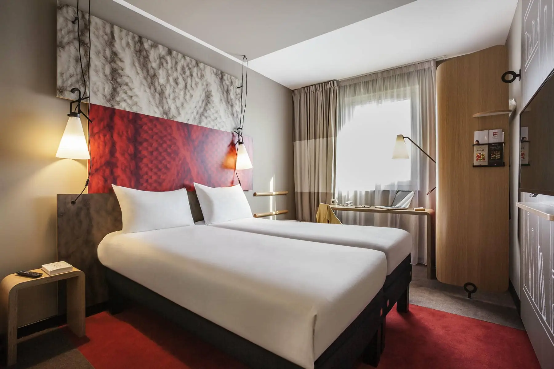 a hotel room with two beds and a desk