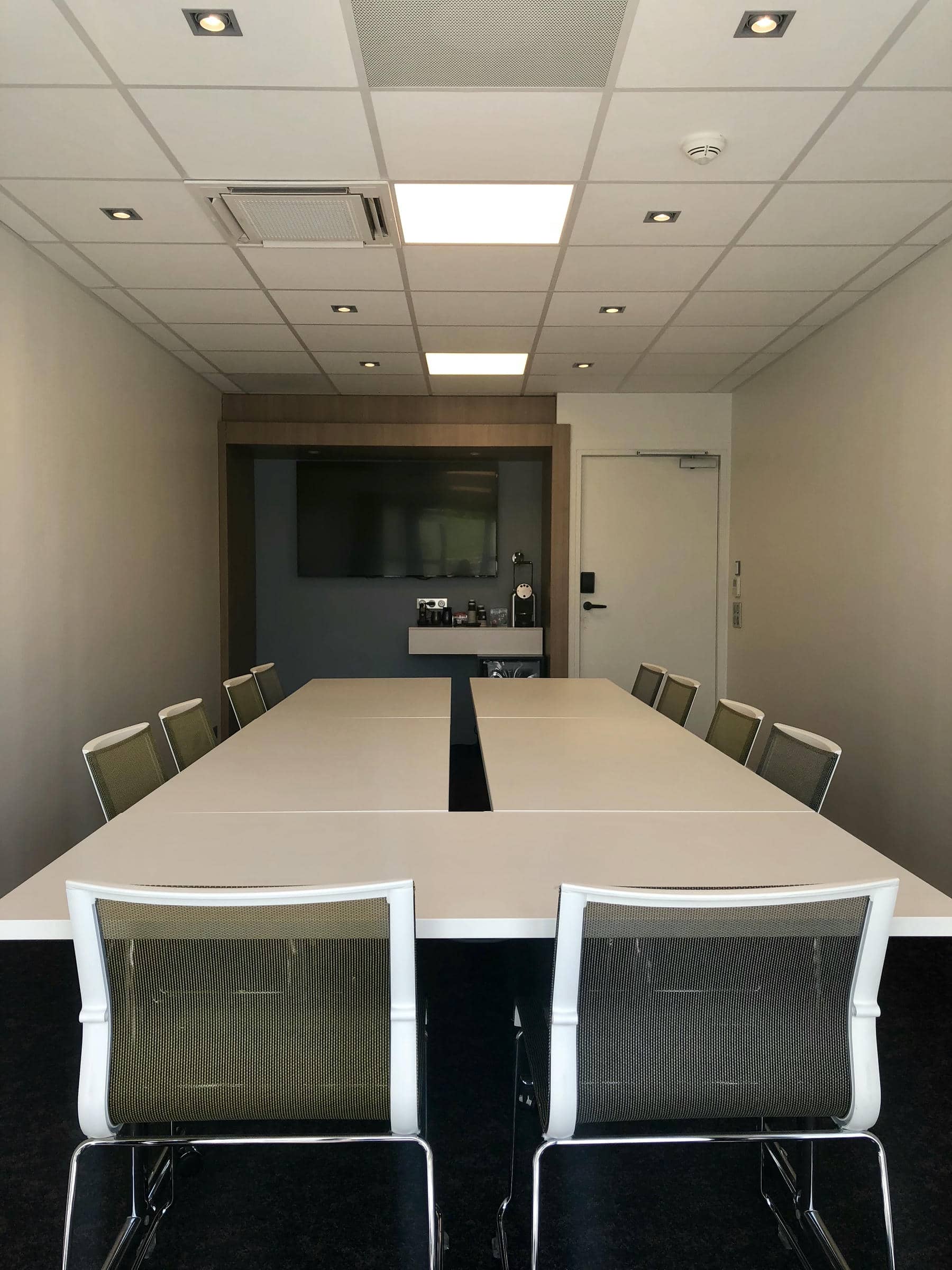 a conference room with a long table and chairs