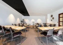 a room with tables and chairs set up for a meeting