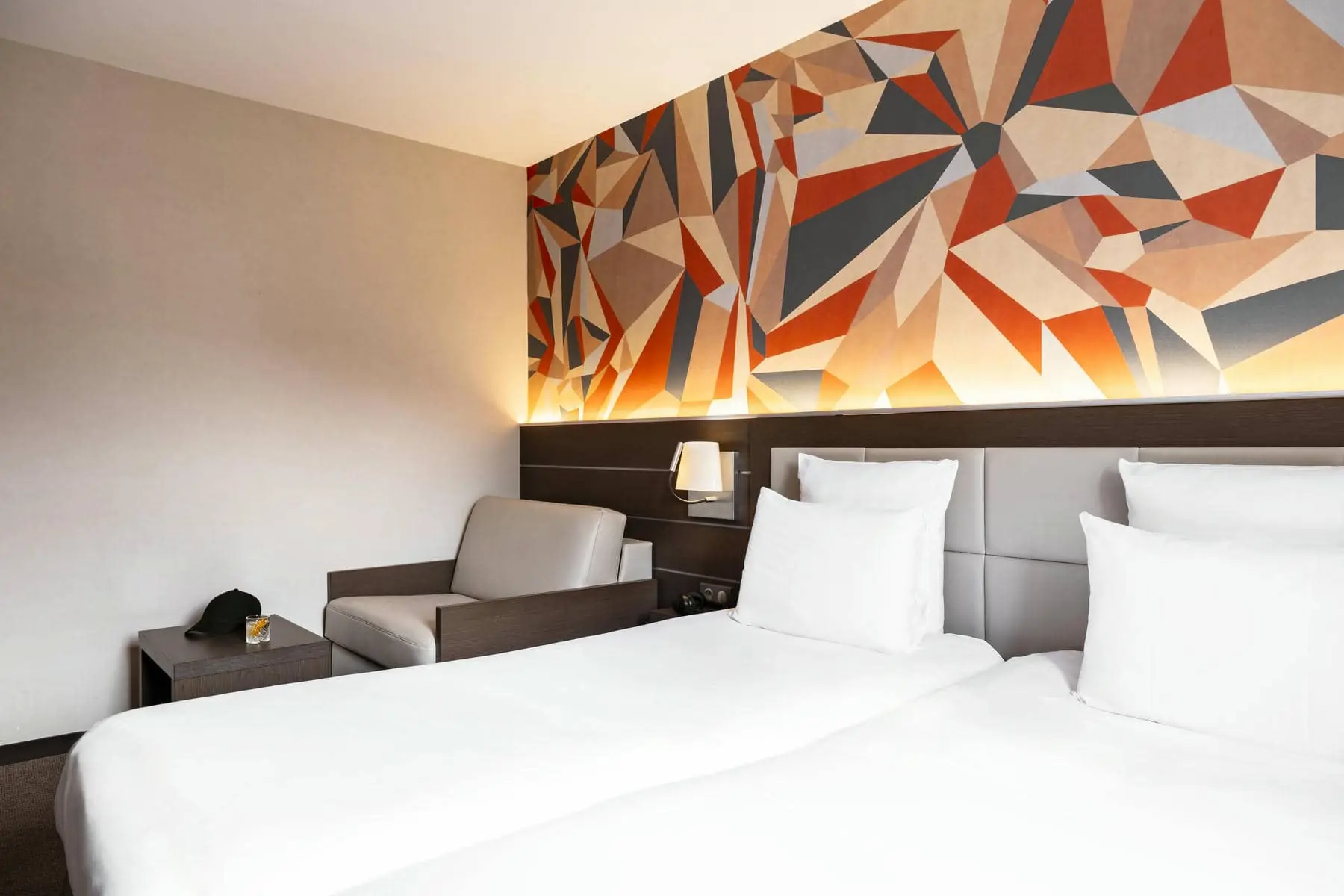 une chambre d'hôtel avec deux lits et une chaise