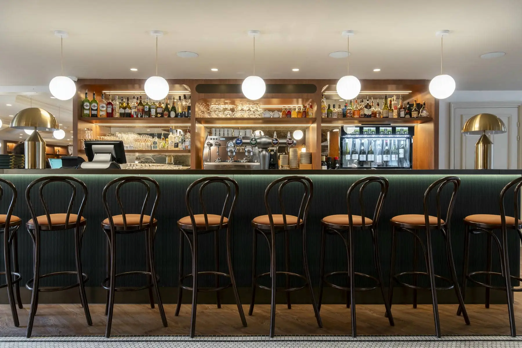 a row of bar stools are lined up in front of a bar