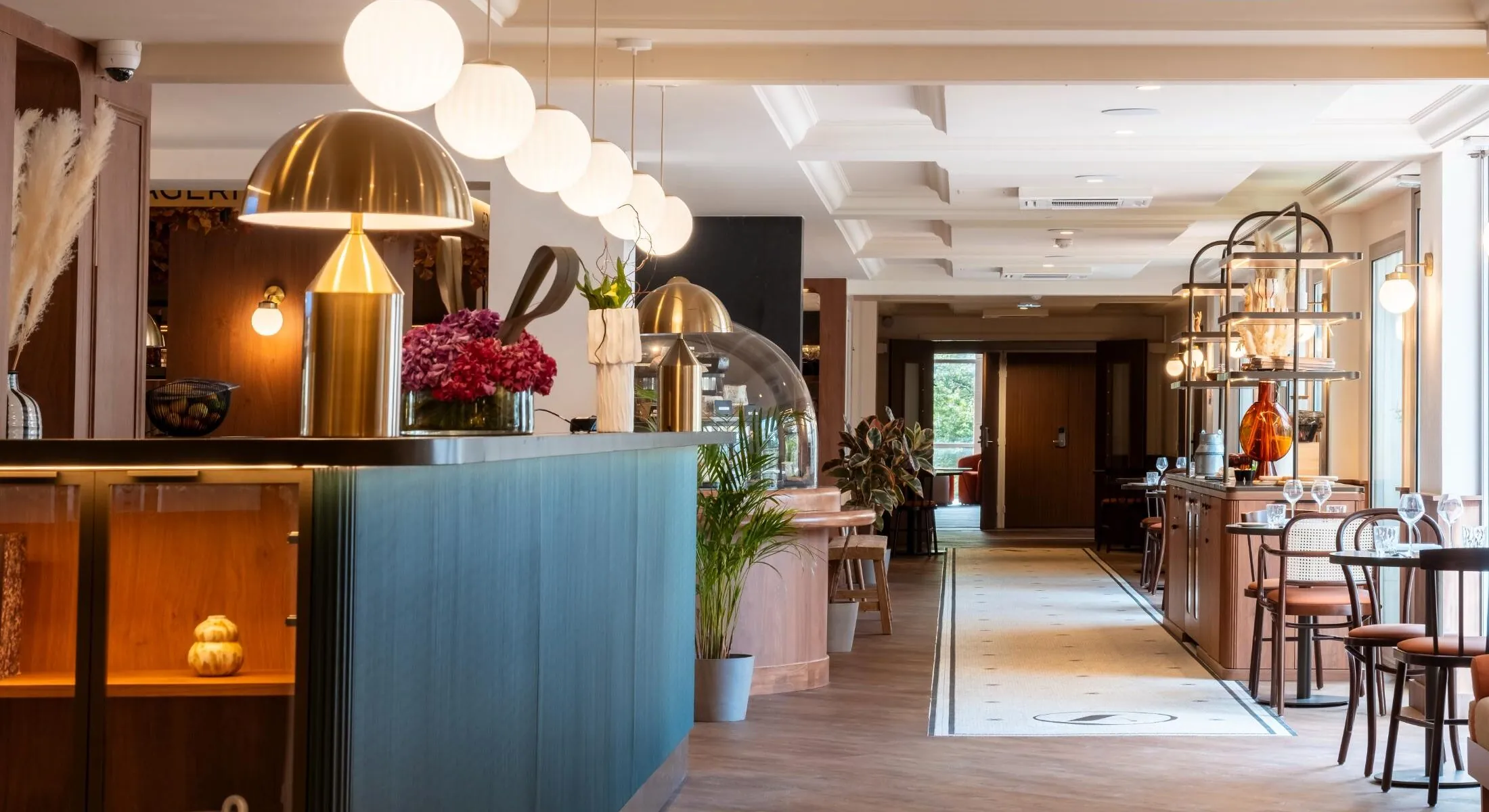 View of the restaurant with tables, counter and refined wooden decoration