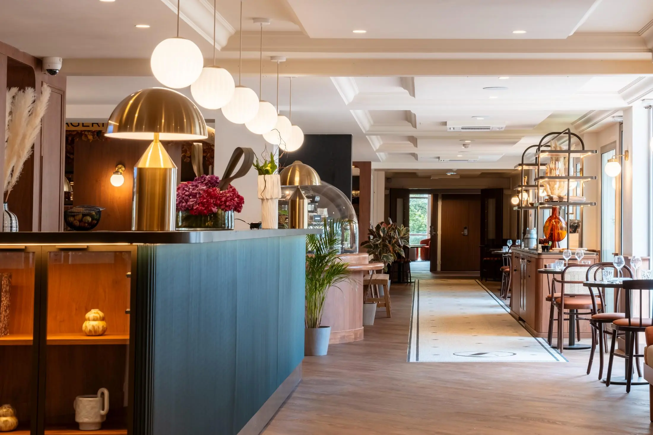 View of the restaurant with tables, counter and refined wooden decoration