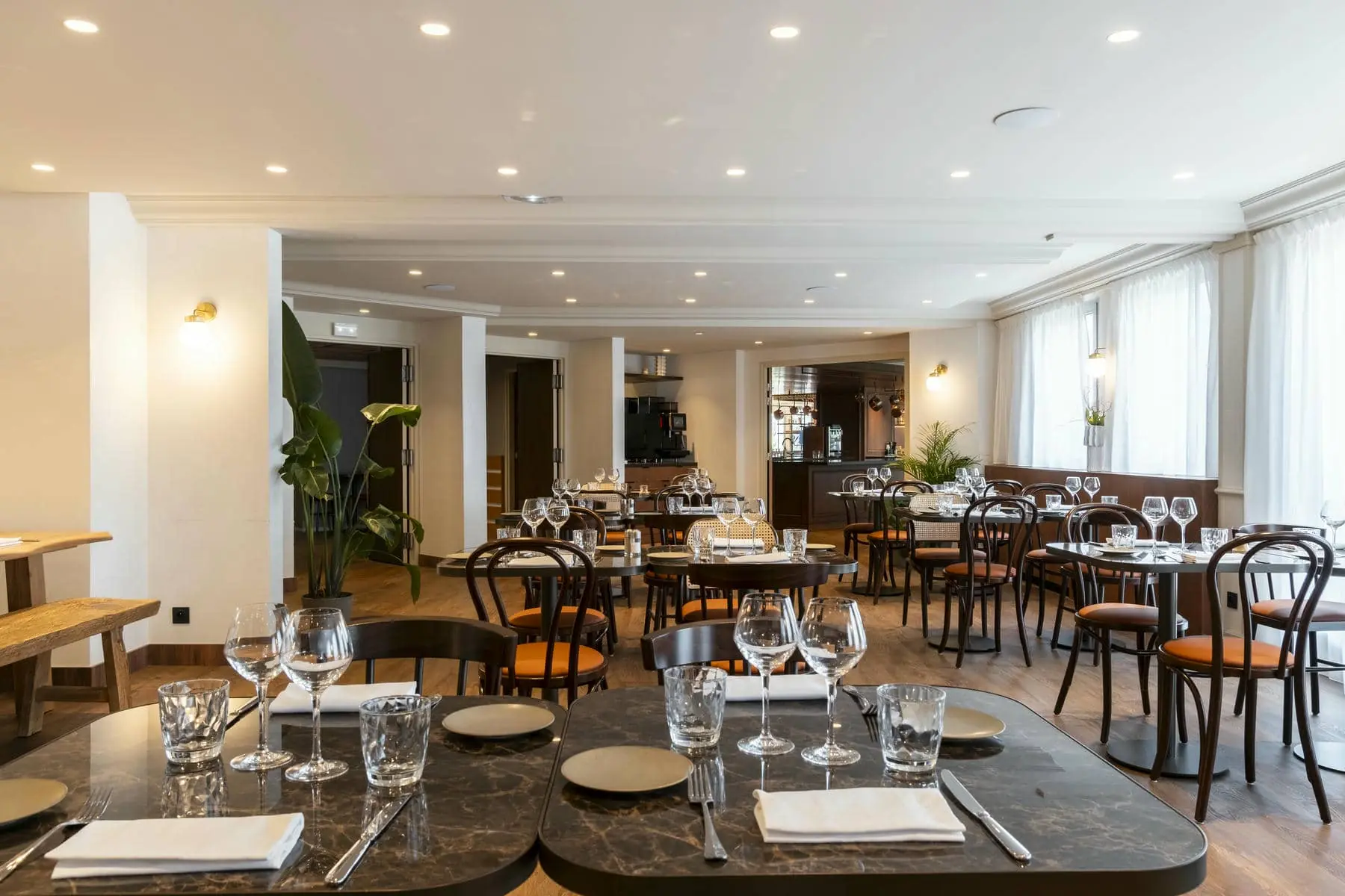 a restaurant with many tables and chairs and a sign that says exit