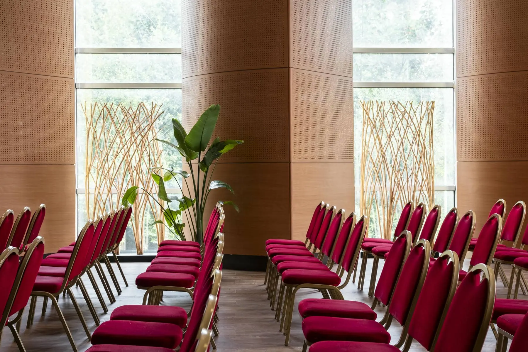 rows of red chairs in front of a window