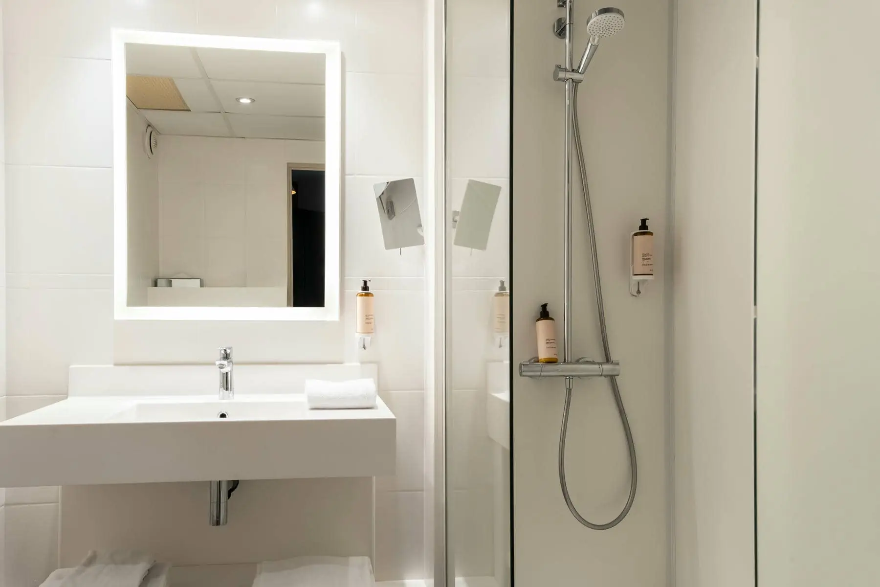 a bathroom with a sink a mirror and a shower