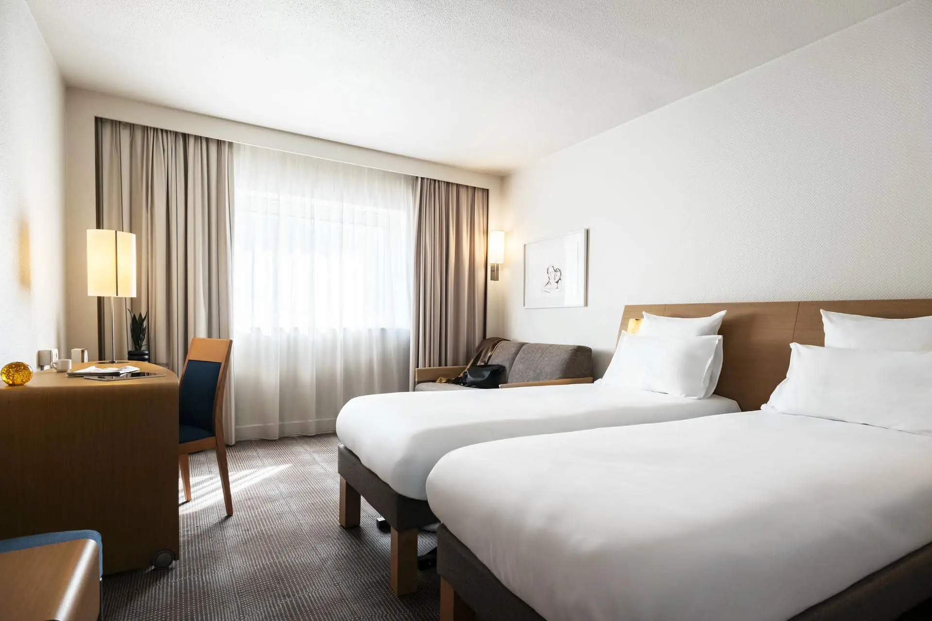 une chambre d'hôtel avec deux lits et un bureau