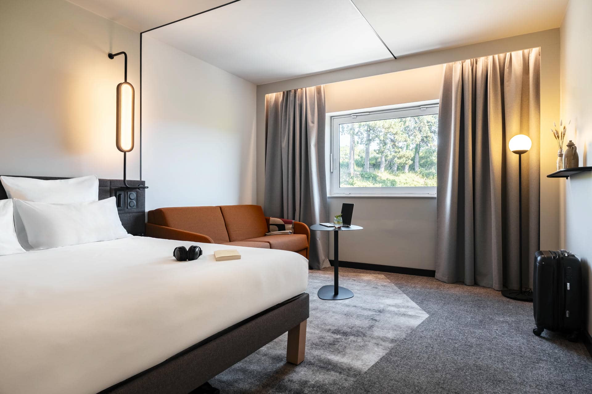 a hotel room with a bed and a couch