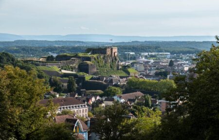 a castle sits on top of a hill overlooking a city