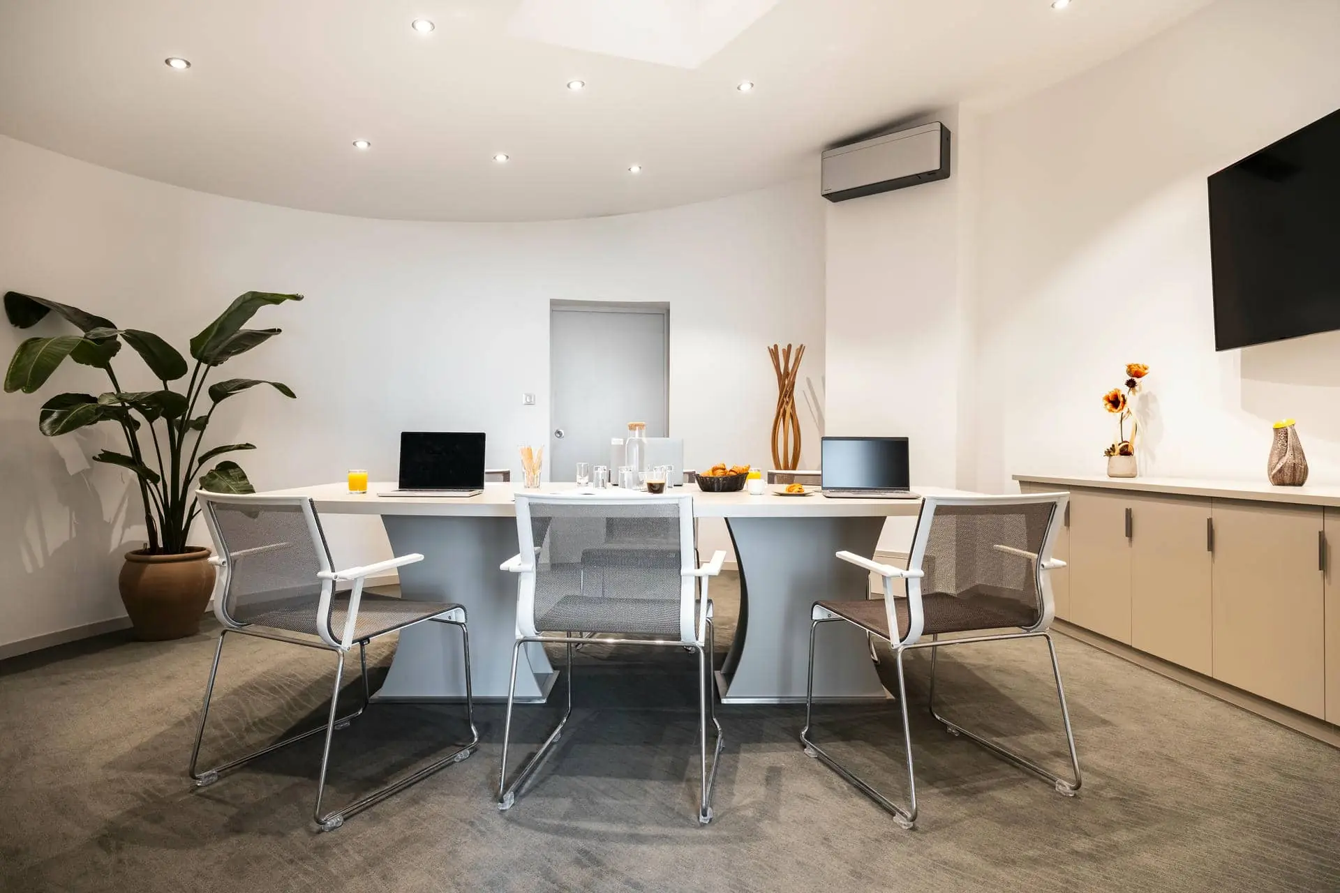 a conference room with a round table and chairs