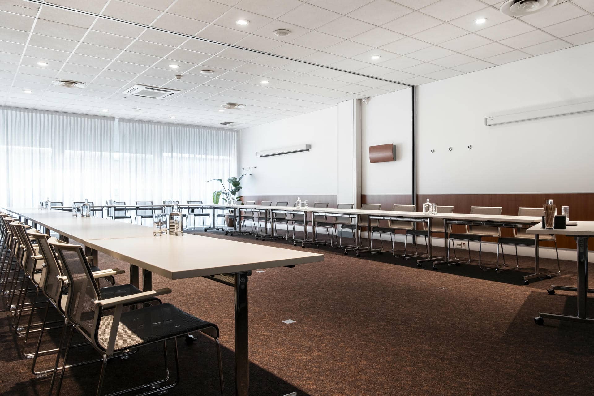 a conference room with long tables and chairs