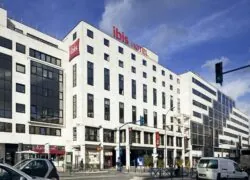 ibis hotel has a red sign on the top of the building