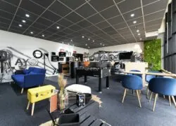 a room with a couch and chairs and a foosball table