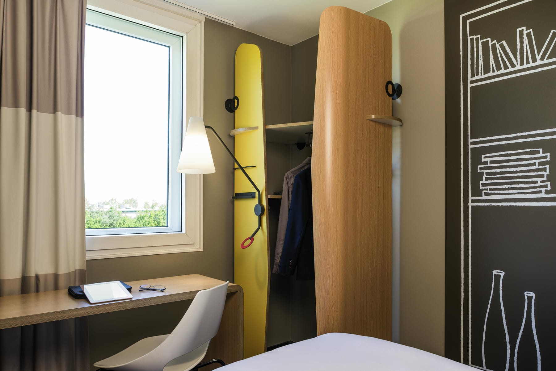 une chambre d'hôtel avec une planche de surf jaune accrochée au mur