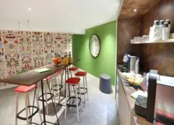 a room with a green wall and a table with stools
