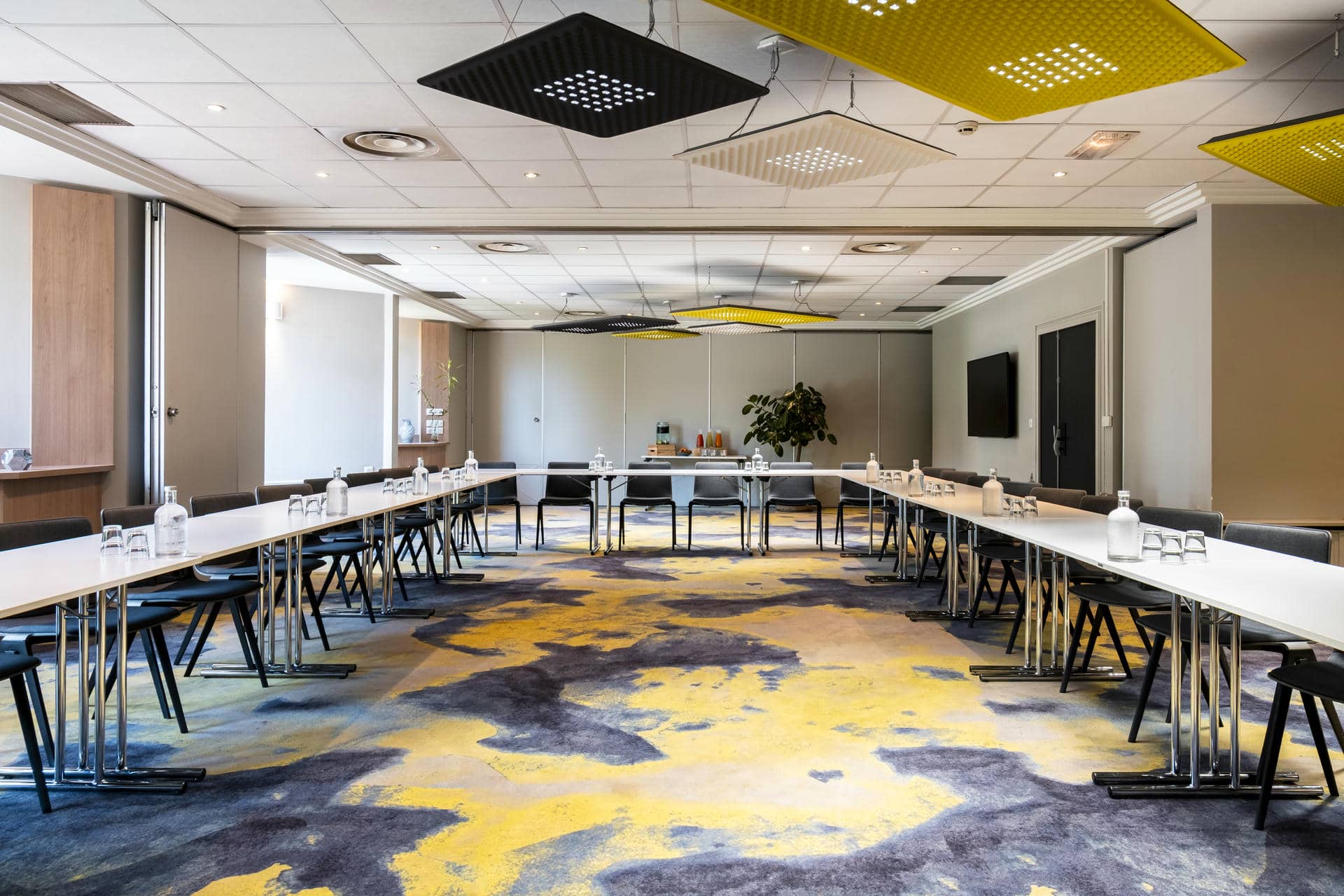 une salle de conférence avec de longues tables et des chaises