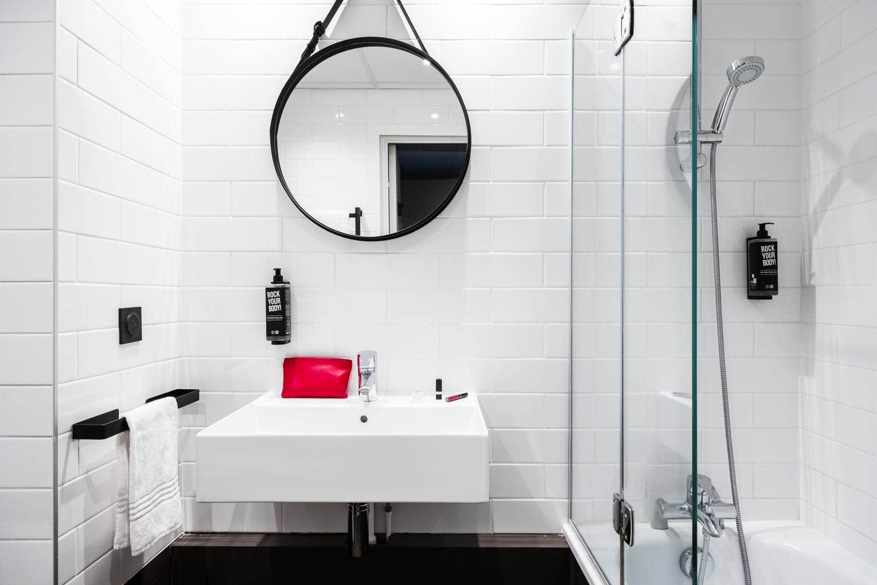 a bathroom with a sink a mirror and a soap dispenser that says black soap