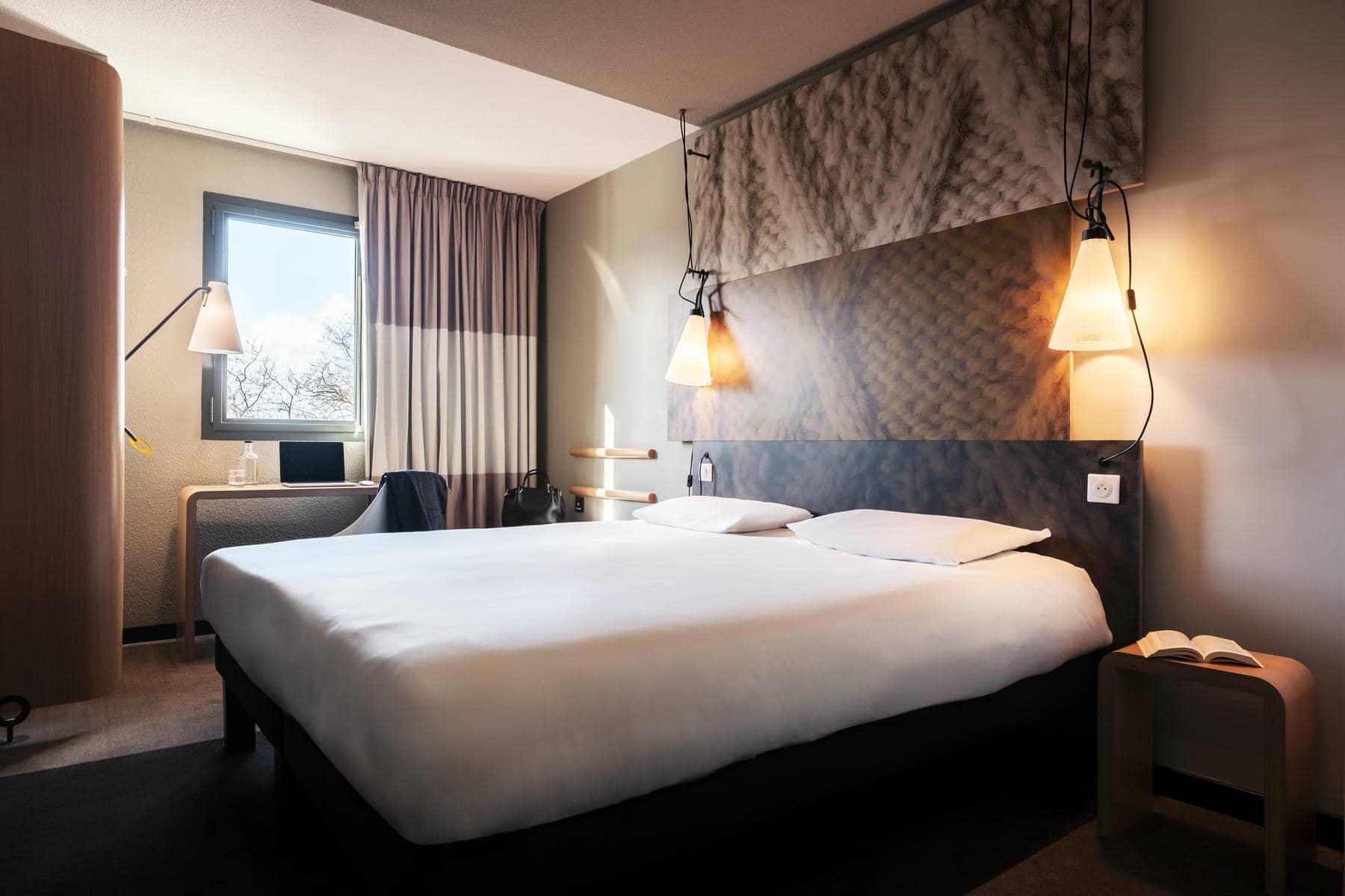 a hotel room with a bed and a desk