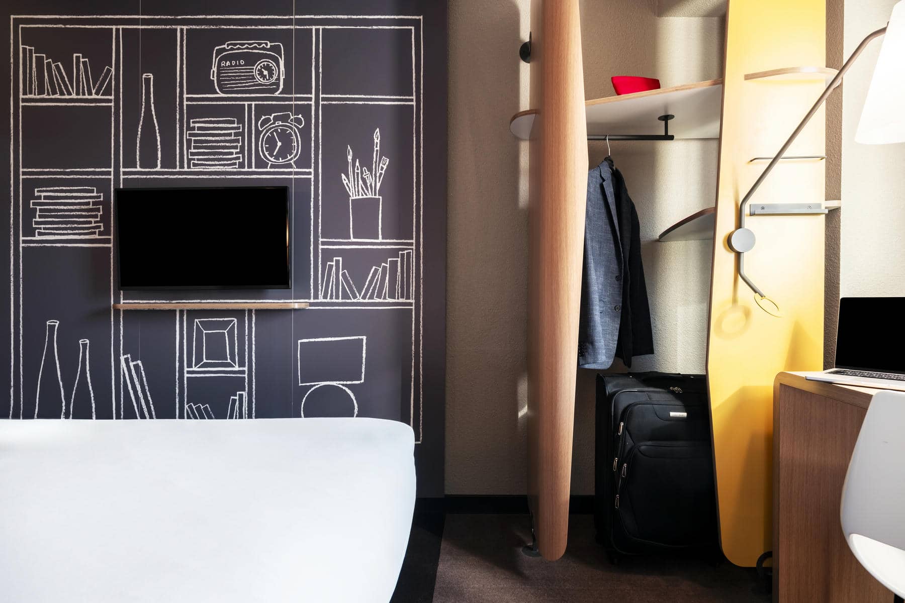 a room with a tv on the wall and a radio on the shelf