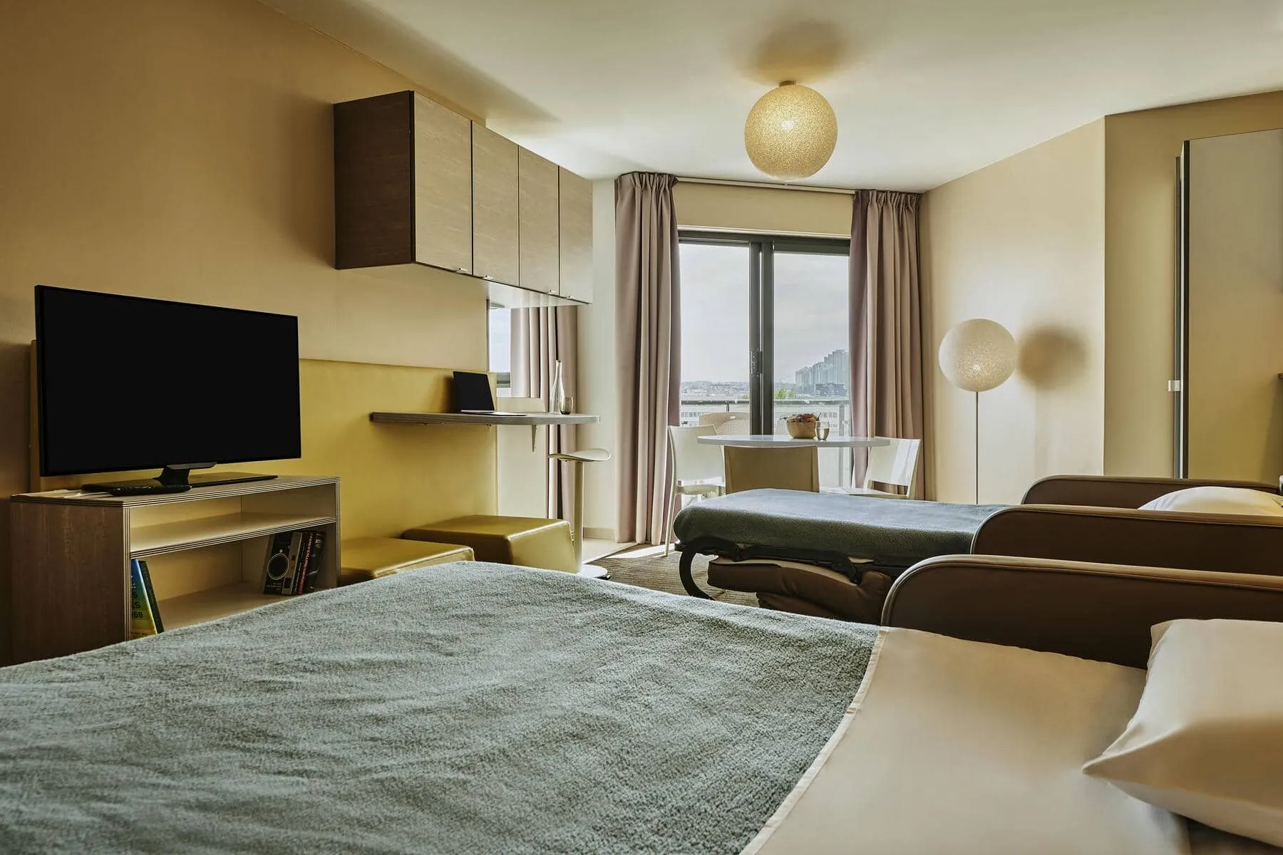 a bedroom with two beds and a flat screen tv