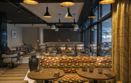 un restaurant avec des tables et des chaises et une grande fenêtre